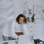 Woman in White Long Sleeve Shirt Sitting on Chair