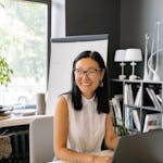 Woman in White Sleeveless Shirt Working at the Office